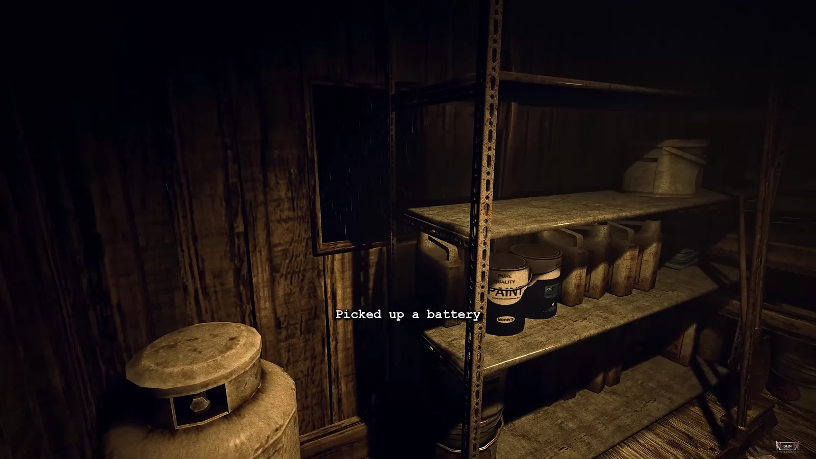 Survival Horror: Outlast gameplay of a dark room with a 'Picked up a battery' notification on screen