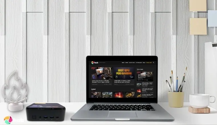 KAMRUI E3B Mini Gaming PC on a white office desk with decorative items for a review