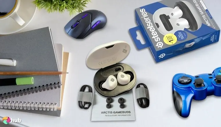 SteelSeries Arctis GameBuds on a white office desk with decorative items for a review