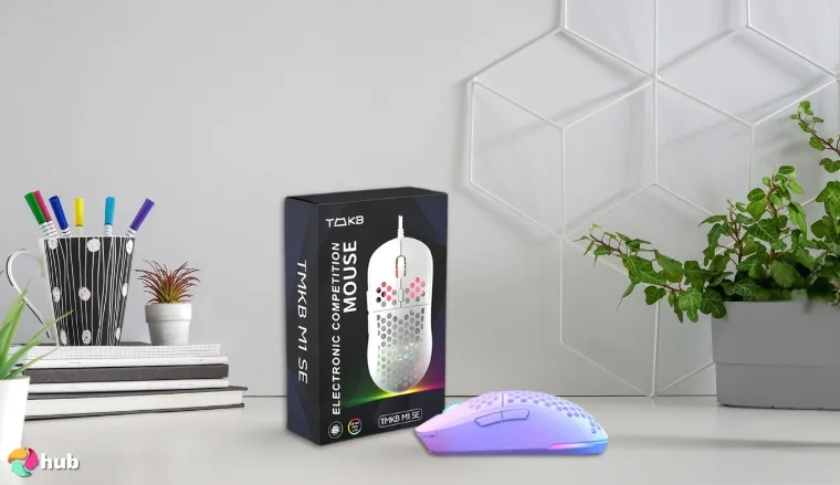 TMKB Falcon M1SE Gaming Mouse on a white office desk with decorative items for a review