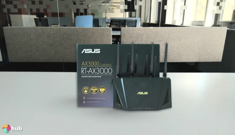 ASUS AX3000 (RT-AX57) Router on a white office desk with simple styling for a review