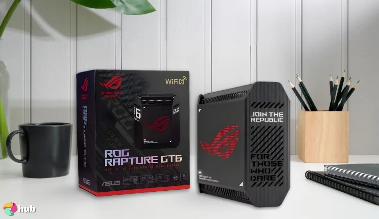 ASUS ROG Rapture GT6 Gaming Router on a white office desk with creative arrangement for a review