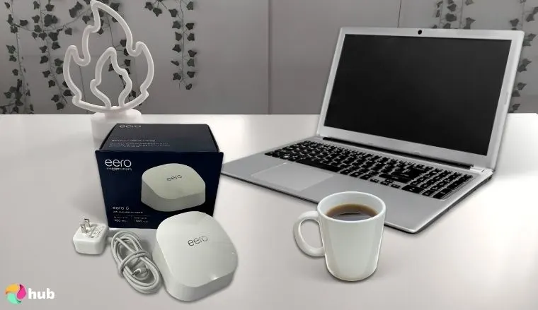 Amazon Eero 6 Router on a white office desk with creative arrangement for a review