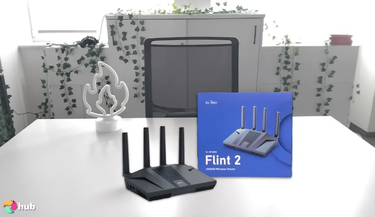 GL.iNet GL‑MT6000 (Flint 2) Gaming Router on a white office desk in a minimalist setup for a review