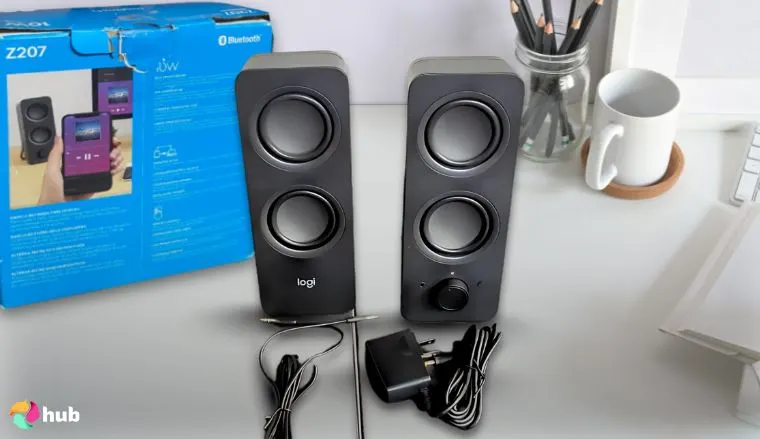Logitech Z207 2.0 Gaming Speakers on a white office desk in a top-down view for a review