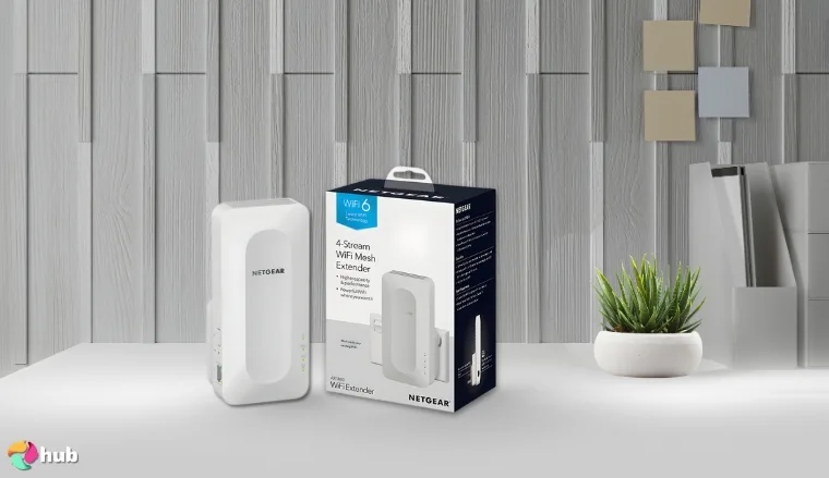 NETGEAR AX1800 (EAX15) Wi-Fi Extender on a white office desk with minimal decor for a review