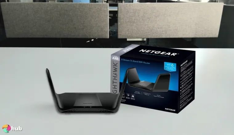 NETGEAR Nighthawk 8-Stream (RAX70) Router on a white office desk styled neatly for a review
