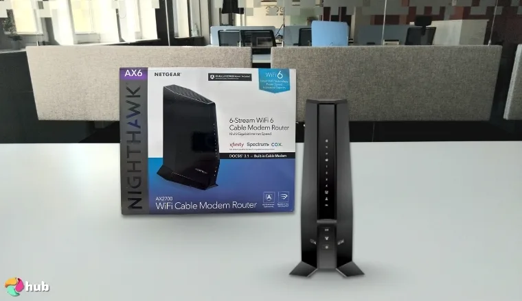 NETGEAR Nighthawk Combo (CAX30) Streaming Router on a white office desk positioned for photography