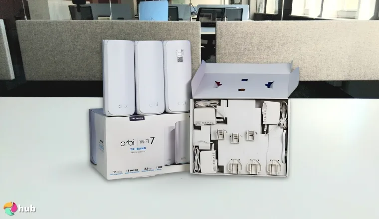 NETGEAR Orbi 870 Series Gaming Router on a white office desk in a well-lit setting for a review