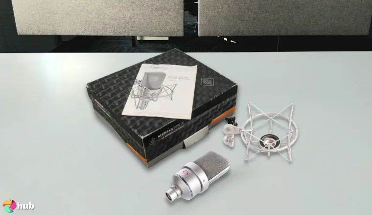 Neumann TLM 103 Microphone on a white office desk in a top-down view for a review