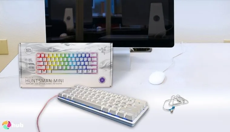 Razer Huntsman Mini Gaming Keyboard on a white office desk with soft lighting for a review