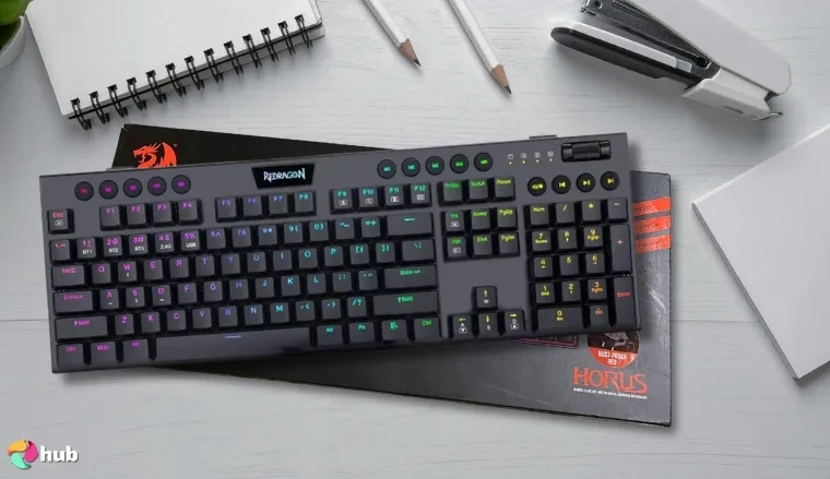 Redragon K618 PRO Gaming Keyboard on a white office desk in a top-down view for a review