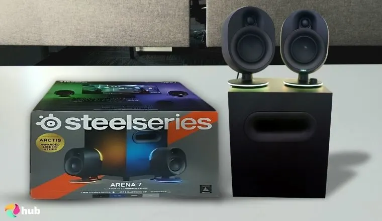SteelSeries Arena 7 Illuminated Gaming Speakers on a white office desk styled for promotional review