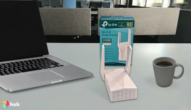 TP-Link RE715X AX3000 Wi-Fi Extender on a white office desk positioned for photography