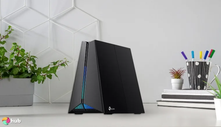 TP-Link Tri‑Band BE11000 Gaming Router on a white office desk prepared for testing shots