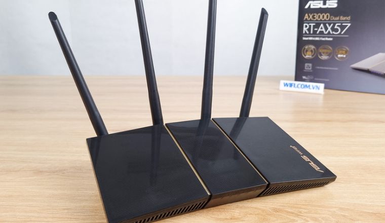 ASUS AX3000 (RT-AX57) router with four antennas on table.