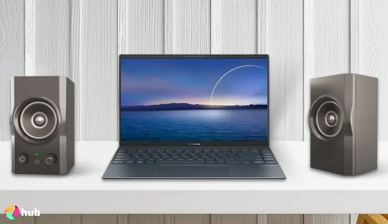 ASUS ZenBook 14 Pro Laptop on a white office desk in a top-down view for a review