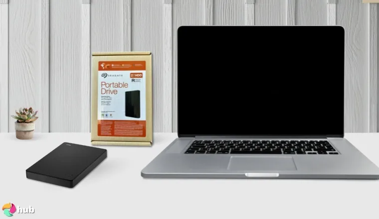 Seagate Portable 2TB External HDD on a white office desk in a well-lit setting for a review
