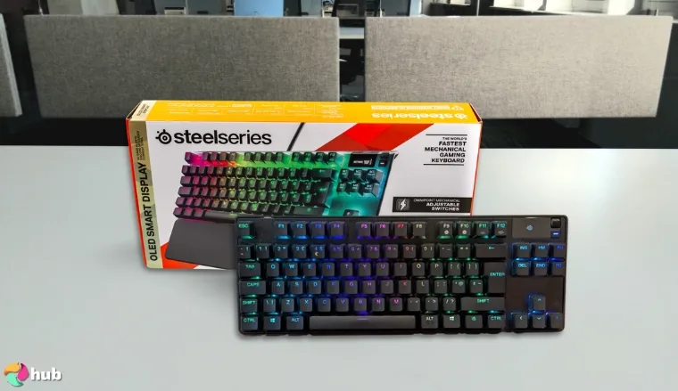 SteelSeries Apex Pro Gaming Keyboard on a white office desk in a clean setup for a review