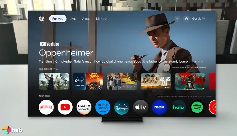 TCL 85-Inch QM7K TV on a white office desk with soft lighting for a review