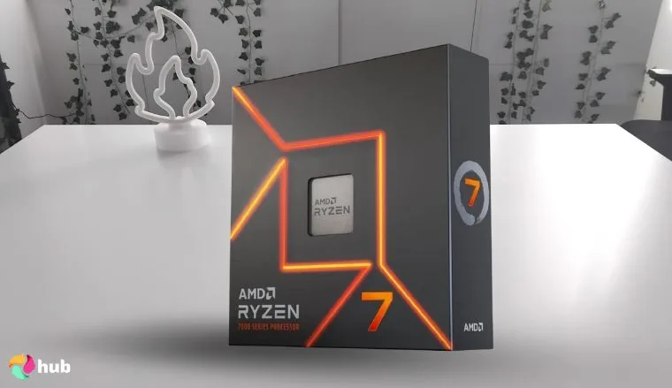 AMD Ryzen 7 7700X CPU on a white office desk styled for promotional review