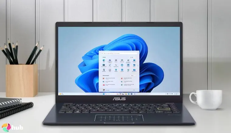 ASUS 14″ FHD Laptop on a white office desk styled for promotional review