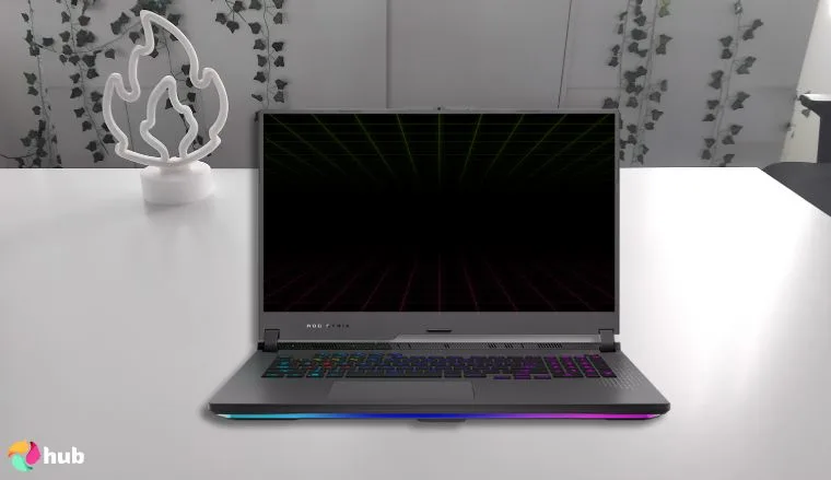 ASUS ROG Strix G17 gaming laptop on a white office desk styled for a review