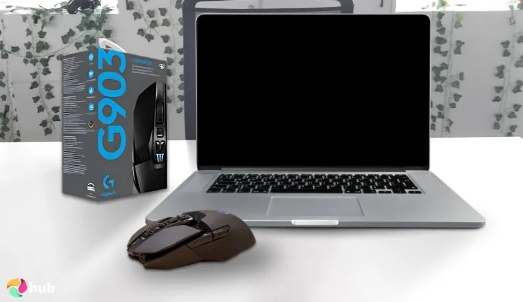 Logitech G903 MMO Mouse on a white office desk with natural shadows for a review