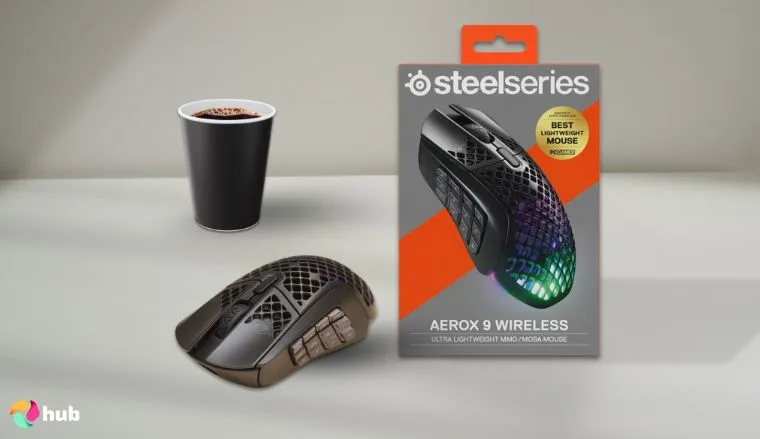 SteelSeries Aerox 9 Wireless MMO Mouse on a white office desk in a minimalist setup for a review