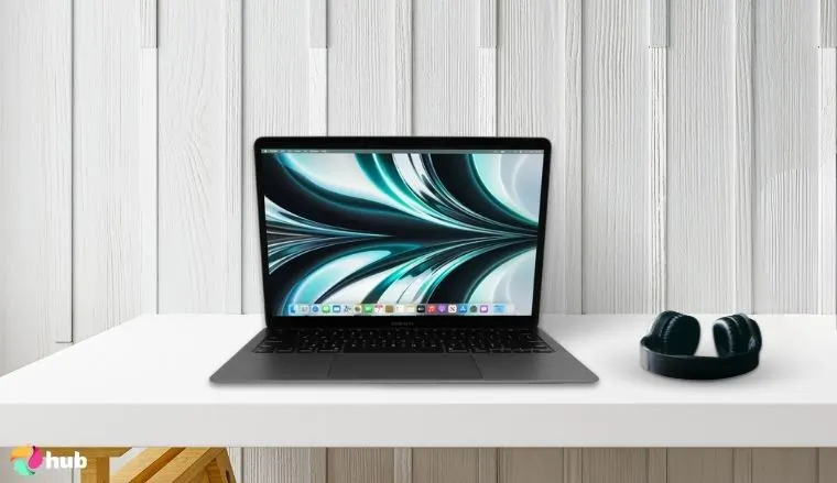 Apple MacBook Air (M1, 2020) on a white office desk in a clean setup for a review