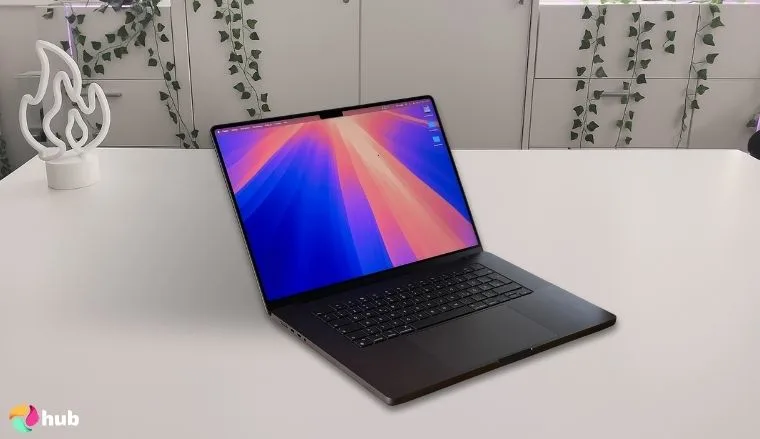 Apple MacBook Pro (16.2 Inch, M4 Max, 2024) on a white office desk in a well-lit setting for a review