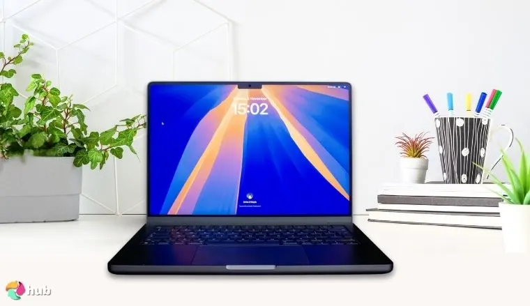 Apple MacBook Pro 2024 on a white office desk in a well-lit setting for a review
