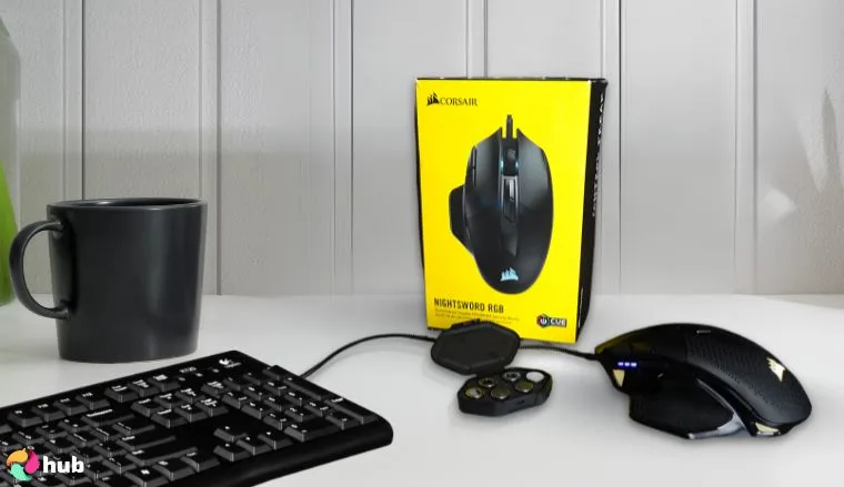 CORSAIR Nightsword RGB Mouse on a white office desk with creative arrangement for a review