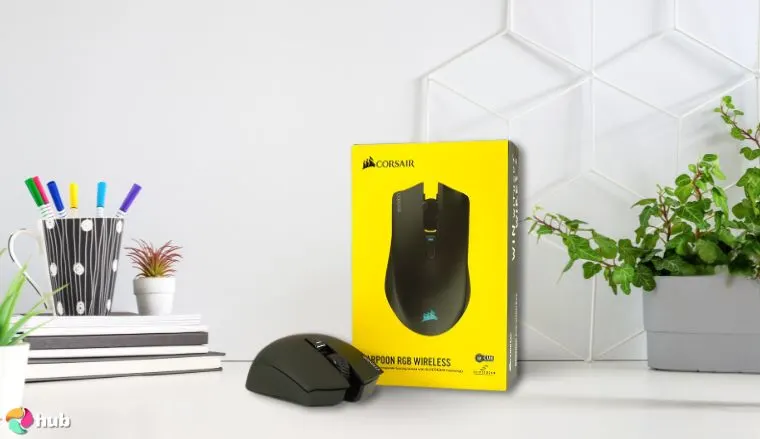 Corsair Harpoon Wireless RGB Gaming Mouse on a white office desk with decorative items for a review