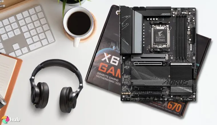 GIGABYTE Ultra Durable X670 Motherboard on a white office desk in a top-down view for a review