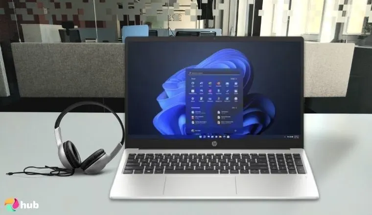 HP 255 G10 Laptop on a white office desk in a clean setup for a review