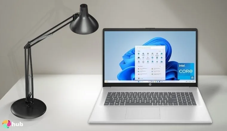 HP Display i5 1334U Graphics 17-cn3399nr Laptop on a white office desk positioned for photography