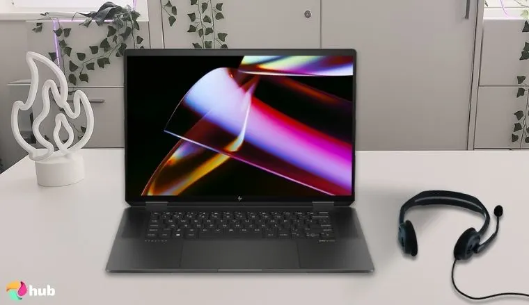 HP Spectre x360 AI Powered 2-in-1 Laptop on a white office desk with decorative items for a review