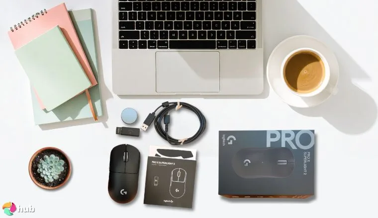 Logitech G Pro x Superlight Gaming Mouse on a white office desk in a well-lit setting for a review