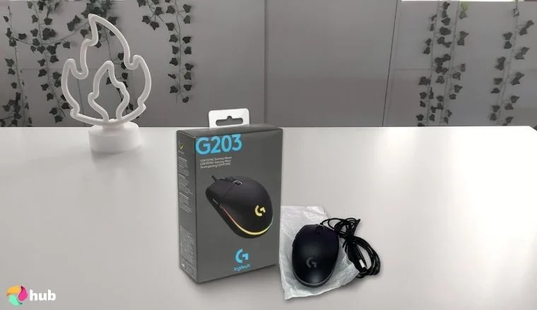 Logitech G203 Wired Gaming Mouse on a white office desk in a minimalist setup for a review
