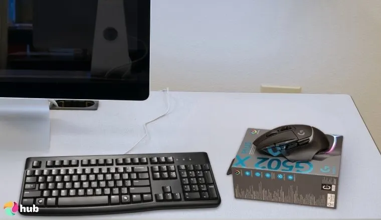Logitech G502 X Plus Mouse on a white office desk positioned for photography