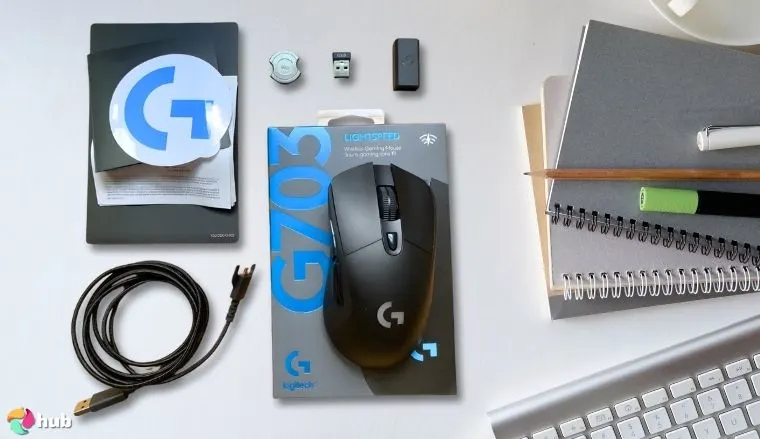 Logitech G703 Gaming Mouse on a white office desk with creative arrangement for a review