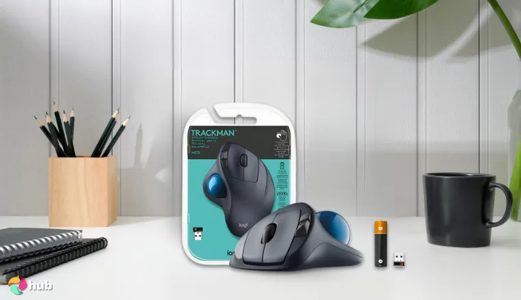 Logitech M570 Mouse on a white office desk in a bright workspace for a review