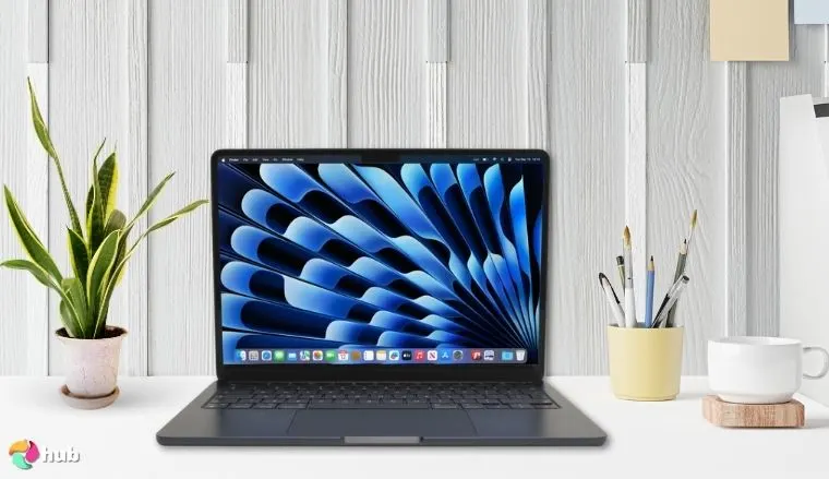 MacBook Air 13-inch (2025) on a white office desk with decorative items for a review