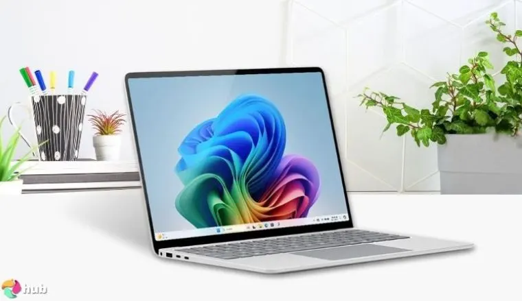 Microsoft Surface Laptop 7 on a white office desk with creative arrangement for a review