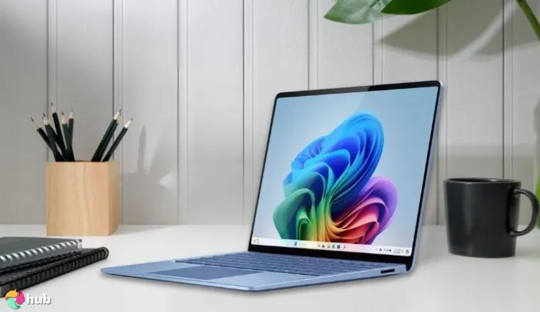 Microsoft Surface Laptop on a white office desk with neat arrangement for a review