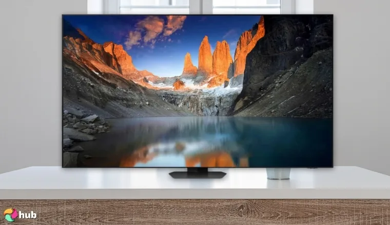 Samsung Neo QLED QN90D TV on a white office desk with soft lighting for a review