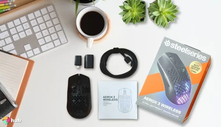 SteelSeries Aerox 3 Gaming Mouse on a white office desk with decorative items for a review