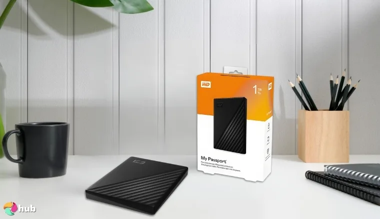 Western Digital My Passport HDD on a white office desk in a top-down view for a review