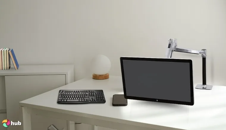 Ergotron LX Single Monitor Desk Mount on a white office desk with natural shadows for a review